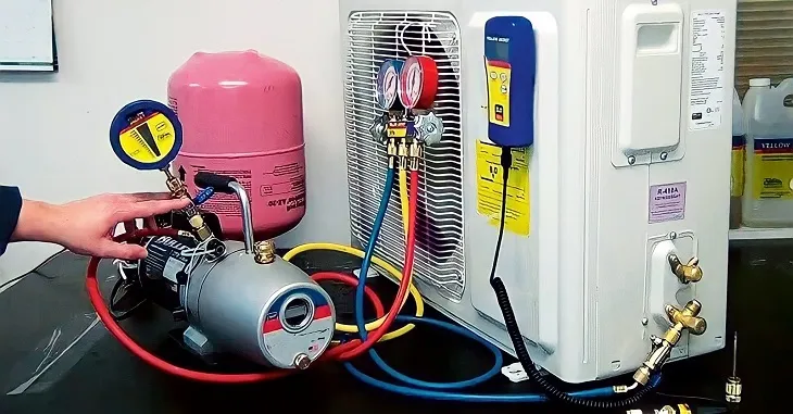 Kỹ thuật viên đang kiểm tra áp suất gas máy lạnh bằng đồng hồ đo